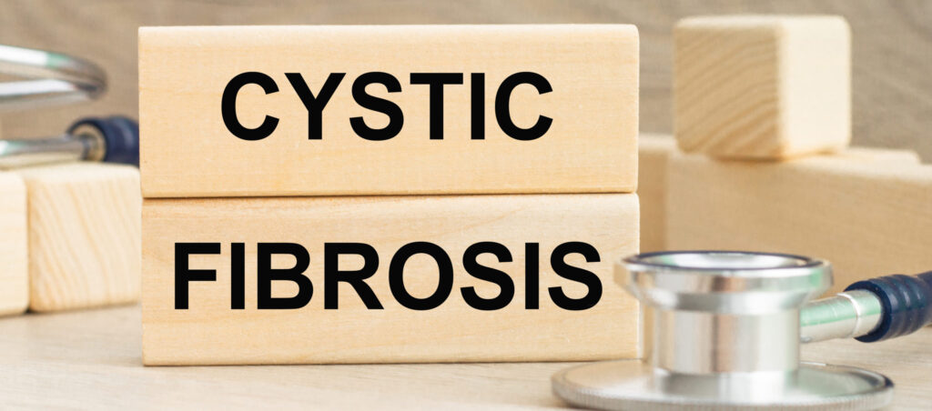 the word CYSTIC FIBROSIS is written on a wooden cubes structure . Can be used for Medical concept.