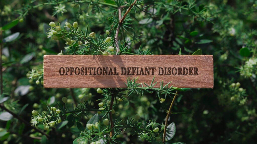 Oppositional Defiant Disorder. Written on wooden surface. Background tree leaves. health and sport