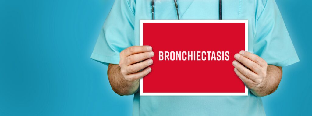 Bronchiectasis. Doctor shows red sign with medical word on it. Blue background.