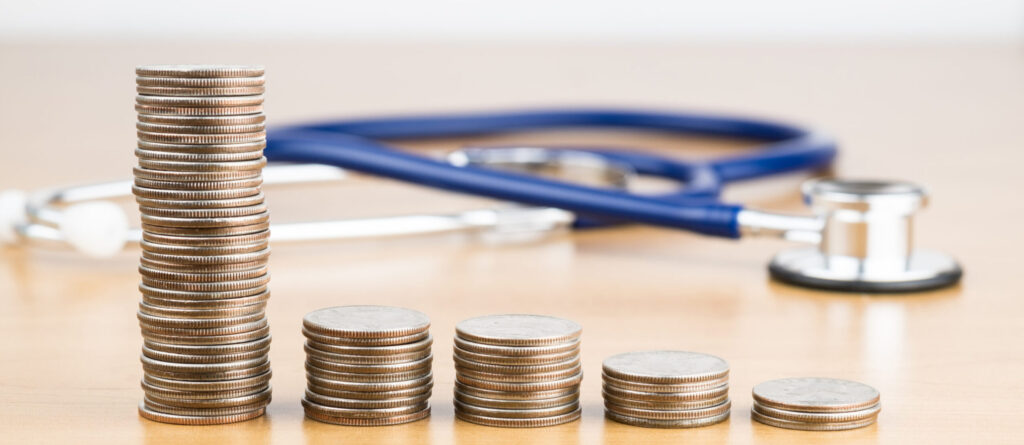 quarters of coverage - STACKED US QUARTER COINS WITH BLUE STETHOSCOPE IN BACKGROUND