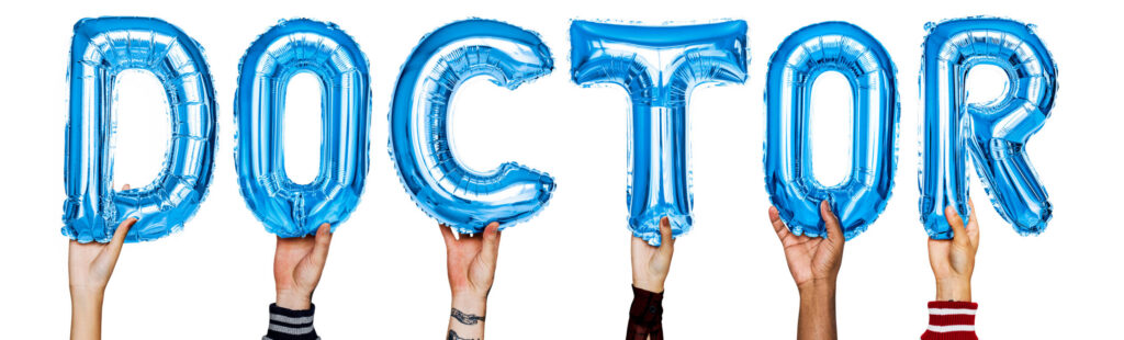 treating doctor - Hands showing doctor balloons word