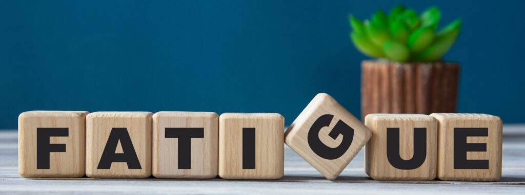 FATIGUE is disabling - word on wooden cubes on the background of a cactus.